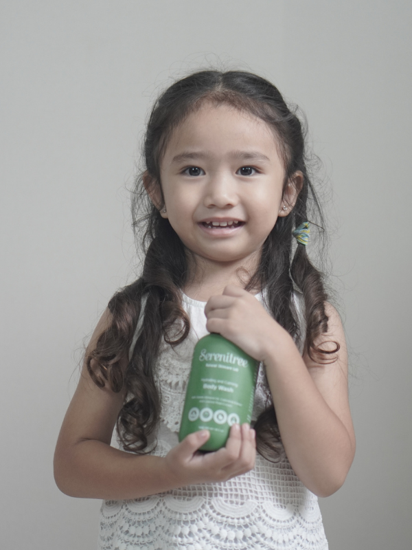 girl holding natural body wash